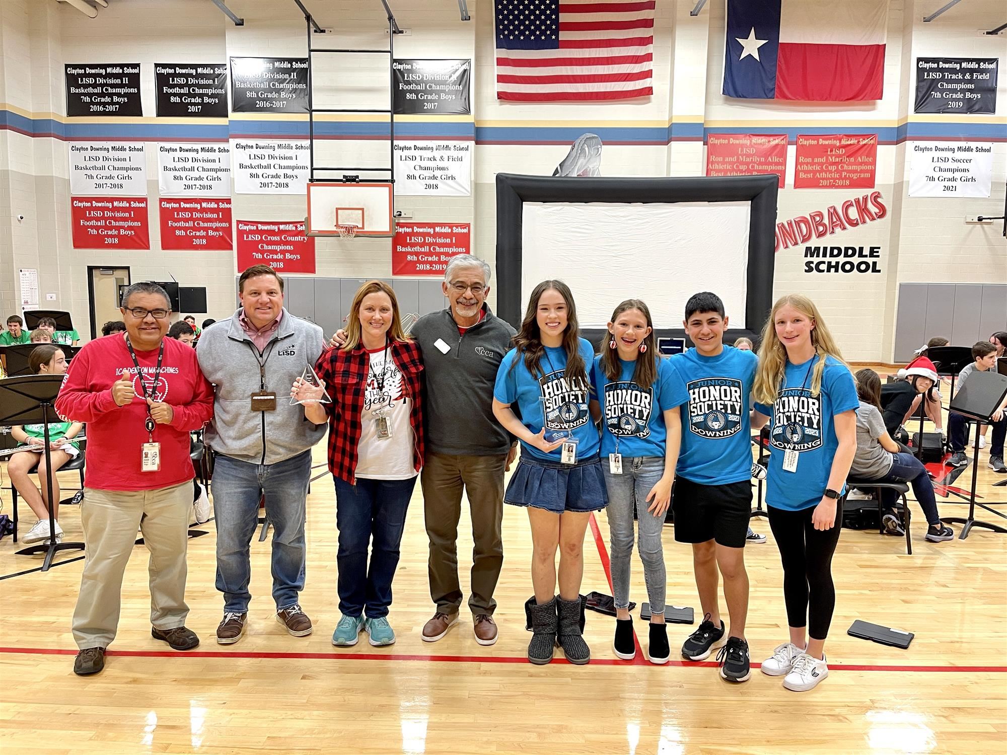 CCA CEO Gilbert Montez presents Downing Middle School with winning trophies for the 2022 Stuff the Pantry Drive.